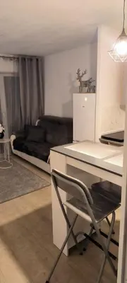 a desk and a chair in a room with a couch at Apartmens 1-st line Cannes Beach in Cannes
