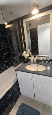 a bathroom with a sink and a mirror and a tub at Apartmens 1-st line Cannes Beach in Cannes