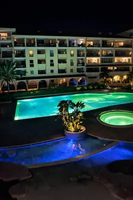 a large apartment building with a swimming pool at night at Apartmens 1-st line Cannes Beach in Cannes