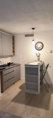 a kitchen with a table and a clock on the wall at Apartmens 1-st line Cannes Beach in Cannes