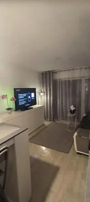 a living room with a flat screen tv on a cabinet at Apartmens 1-st line Cannes Beach in Cannes