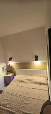 a bedroom with a bed with two lights on it at Apartmens 1-st line Cannes Beach in Cannes