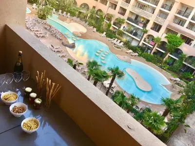 a view of a pool from the balcony of a hotel at Apartmens 1-st line Cannes Beach in Cannes