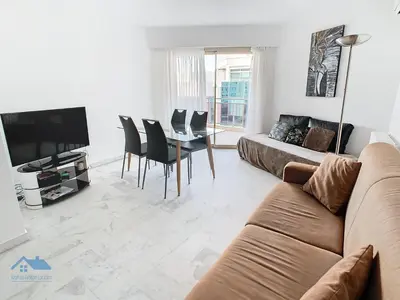 a living room with a couch and a table at Appartements derrière Croisette in Cannes