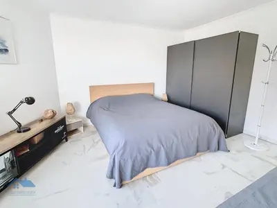 a bedroom with a bed and a dresser in it at Appartements derrière Croisette in Cannes