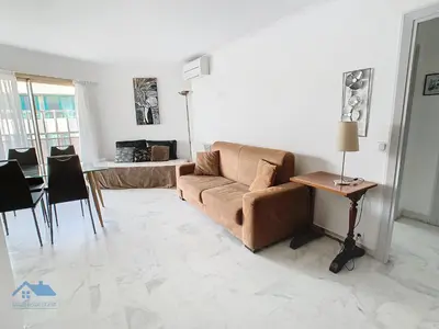 a living room with a couch and a table at Appartements derrière Croisette in Cannes