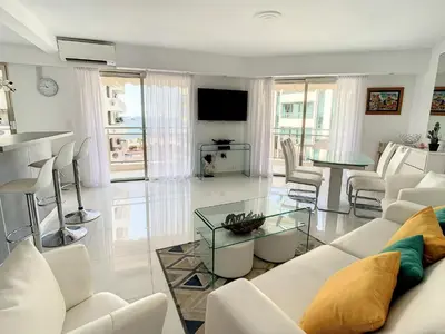 a living room with a white couch and a table at Appartements derrière Croisette in Cannes