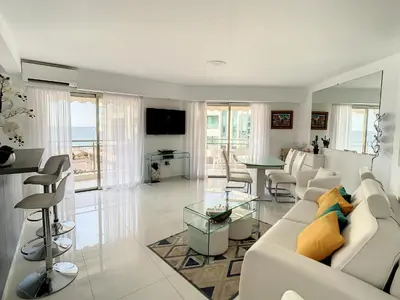 a living room with a white couch and a table at Appartements derrière Croisette in Cannes