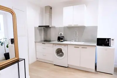 a white kitchen with a washing machine and a sink at Au coeur du vieux Cannes - 2 pièces - 4 couchages - 500 m du Palais des Festivals in Cannes