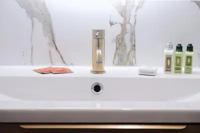 a bathroom sink with a faucet and bottles of soap at Au coeur du vieux Cannes - 2 pièces - 4 couchages - 500 m du Palais des Festivals in Cannes