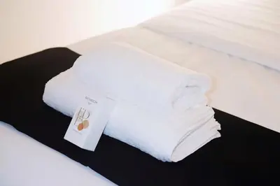 a white blanket on a bed with a sign on it at Au coeur du vieux Cannes - 2 pièces - 4 couchages - 500 m du Palais des Festivals in Cannes