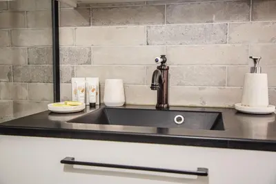 a kitchen counter with a sink and a mirror at Sunny Duplex by Connexion in Cannes