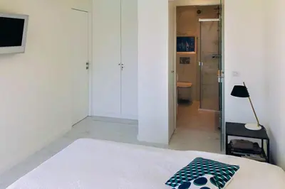 a bedroom with a bed and a walk in shower at Sea view apartment-3 pers-with pool-Cannes in Cannes