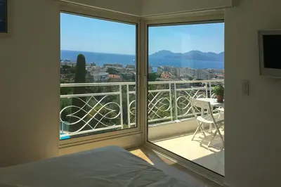a bedroom with a view of a balcony at Sea view apartment-3 pers-with pool-Cannes in Cannes