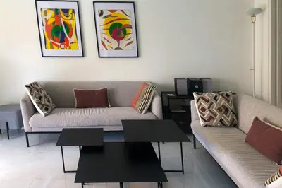 a living room with two couches and a coffee table at Sea view apartment-3 pers-with pool-Cannes in Cannes