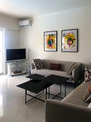 a living room with a couch and a flat screen tv at Sea view apartment-3 pers-with pool-Cannes in Cannes