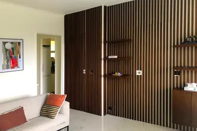 a living room with a couch and a wooden wall at Sea view apartment-3 pers-with pool-Cannes in Cannes