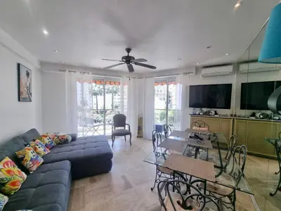 a living room with a couch and a table at Velasquez Martinez Plage in Cannes