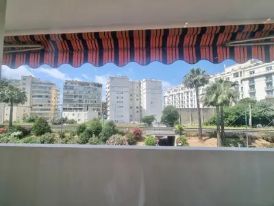 a window with a view of a city at Velasquez Martinez Plage in Cannes
