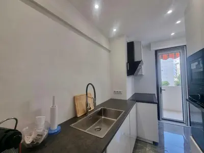 a kitchen with a sink and a counter top at Velasquez Martinez Plage in Cannes