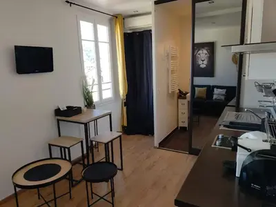 a living room with chairs and a table and a living room at Studio lumineux, Centre ville, Palais Festivals in Cannes