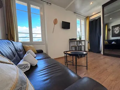 a living room with a couch and a table at Studio lumineux, Centre ville, Palais Festivals in Cannes