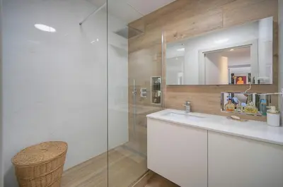 a bathroom with a sink and a glass shower at FRGK Air-Conditioned Duplex with Terrace Secure Residence & Premium Amenities in Cannes