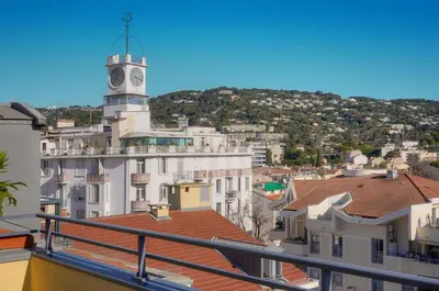 a view of a city with a clock tower at FRGK Air-Conditioned Duplex with Terrace Secure Residence & Premium Amenities in Cannes