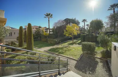 a view of a garden with palm trees and bushes at FRGK Air-Conditioned Duplex with Terrace Secure Residence & Premium Amenities in Cannes