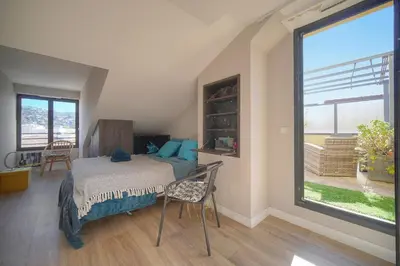 a bedroom with a bed and a large window at FRGK Air-Conditioned Duplex with Terrace Secure Residence & Premium Amenities in Cannes