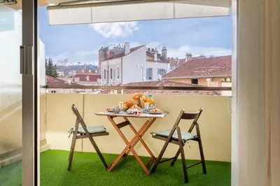 a table and two chairs on a balcony at Le Cocon - City centre - Terrace - AC - Cosy in Cannes