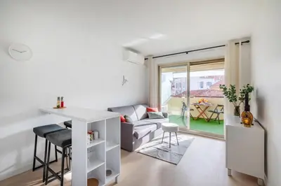 a living room with a couch and a table at Le Cocon - City centre - Terrace - AC - Cosy in Cannes
