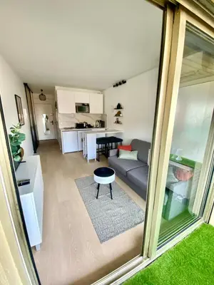 a living room with a couch and a table at Le Cocon - City centre - Terrace - AC - Cosy in Cannes