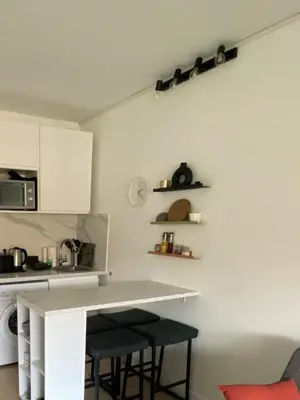 a kitchen with a white counter and stools at Le Cocon - City centre - Terrace - AC - Cosy in Cannes