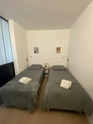 two twin beds in a room with two lamps at Le Cocon - City centre - Terrace - AC - Cosy in Cannes