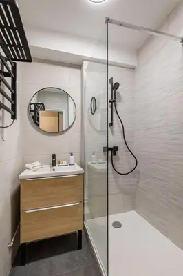 a bathroom with a shower and a sink and a mirror at Le Cocon - City centre - Terrace - AC - Cosy in Cannes