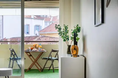 a room with a table with a vase on a refrigerator at Le Cocon - City centre - Terrace - AC - Cosy in Cannes