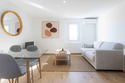 a living room with a couch and a glass table at Charme au Suquet 1 Chambre & Canapé-Lit AC in Cannes