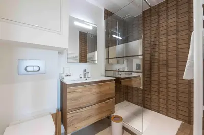 a bathroom with a sink and a shower at Charme au Suquet 1 Chambre & Canapé-Lit AC in Cannes