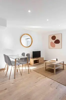 a dining room with a glass table and chairs at Charme au Suquet 1 Chambre & Canapé-Lit AC in Cannes