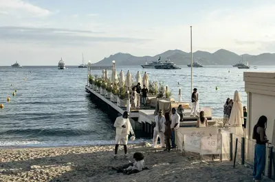 a group of people standing on a dock on the beach at Charmant 2 pièces cœur du Suquet Proche Palais in Cannes