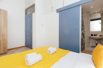 a bedroom with a large bed with towels on it at Mouette YourHostHelper in Cannes