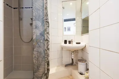 a bathroom with a sink and a shower at Mouette YourHostHelper in Cannes