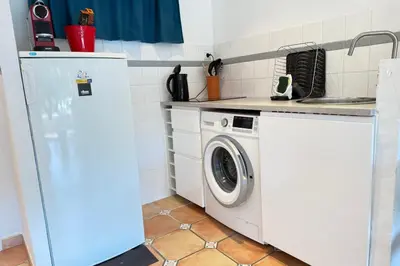 a bedroom with a bed and a television and a balcony at One-bedroom apt ideally located in front of the Midi beaches in Cannes