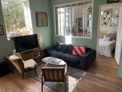 a living room with a couch and a tv at Sentez-vous comme à la maison près du palais in Cannes