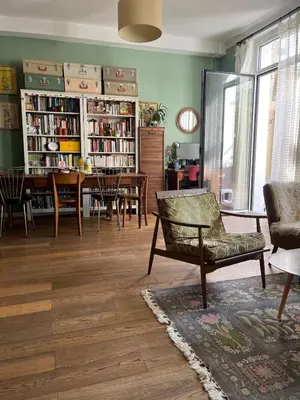 a living room with a chair and a dining room at Sentez-vous comme à la maison près du palais in Cannes