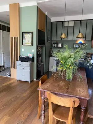 a kitchen and living room with a table and chairs at Sentez-vous comme à la maison près du palais in Cannes