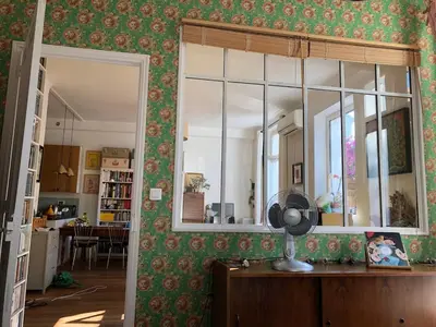 a room with a mirror and a fan on a table at Sentez-vous comme à la maison près du palais in Cannes
