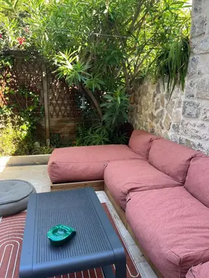 a couch sitting on a patio with a table at Sentez-vous comme à la maison près du palais in Cannes