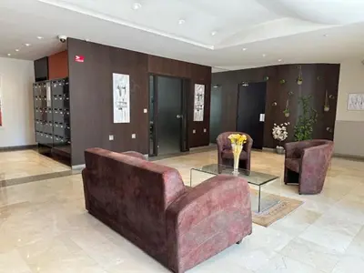 a living room with a couch and two chairs and a table at Congress et Comfort in Cannes